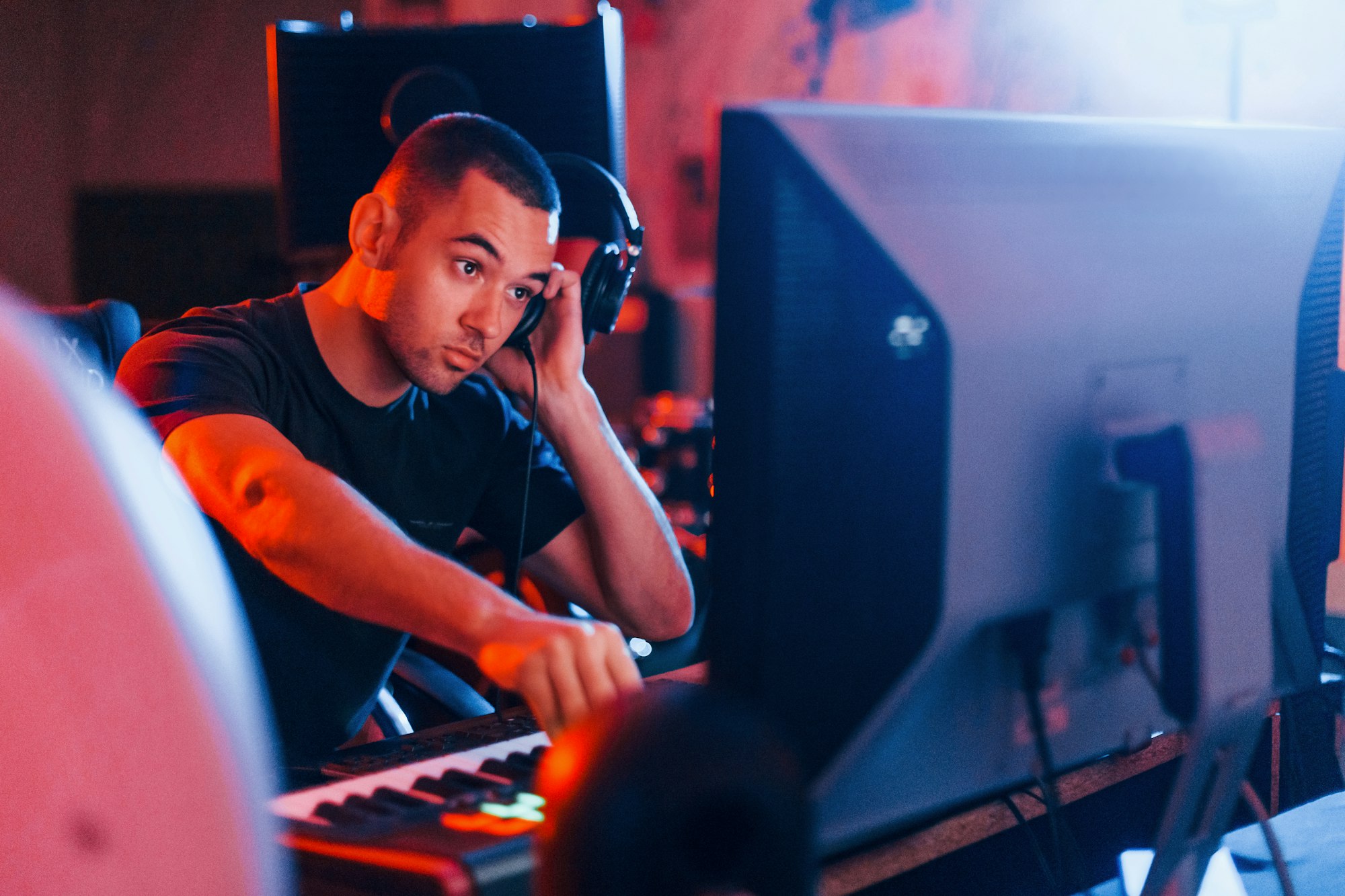 Sound engineer working and mixing music indoors in the studio